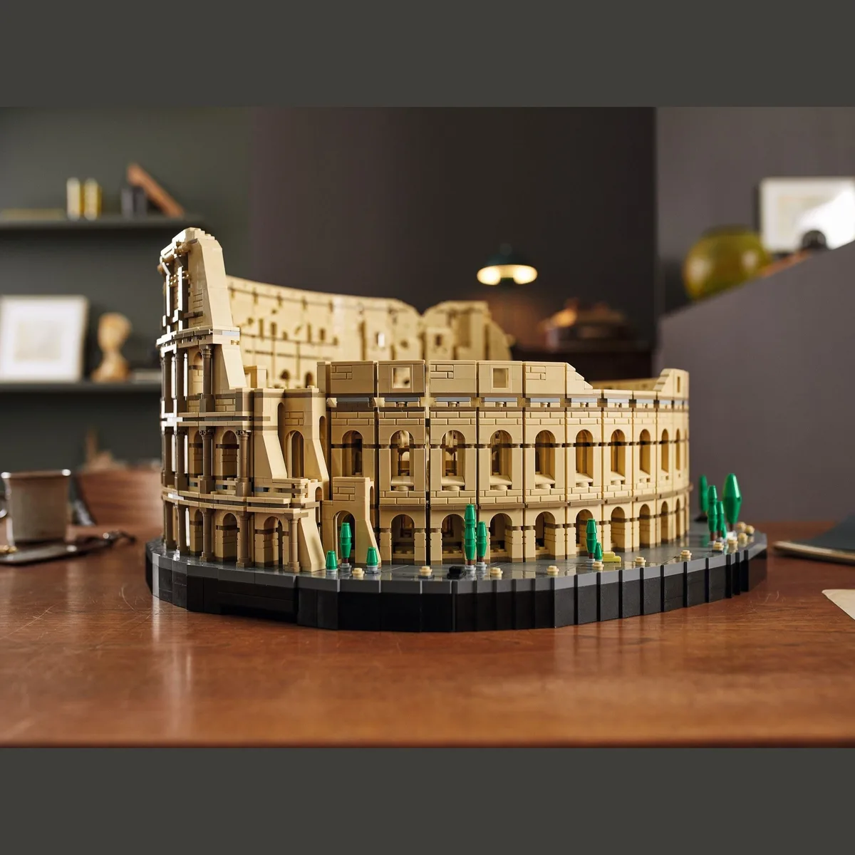 A finished brick amphitheatre on a wooden shelf in a dark study